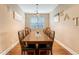 Formal dining room with a large table, hardwood floors, and stylish decor for elegant entertaining at 708 Professor Dr, Ladson, SC 29456