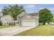 Charming two-story home featuring a manicured lawn and a spacious two-car garage at 708 Professor Dr, Ladson, SC 29456