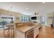 Open concept kitchen featuring stainless appliances, a breakfast bar, and hardwood floors leading to the dining area at 708 Professor Dr, Ladson, SC 29456