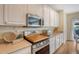 Charming kitchen with stainless steel appliances, white cabinets, and natural light at 708 Professor Dr, Ladson, SC 29456