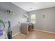 Well-lit laundry room features modern washer and dryer, and practical storage shelves at 708 Professor Dr, Ladson, SC 29456