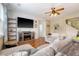 Cozy living room with modern entertainment setup, hardwood floors, and seamless flow into other living spaces at 708 Professor Dr, Ladson, SC 29456