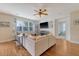 Comfortable living room featuring a sectional sofa, hardwood floors, and a bright, airy feel from the large window at 708 Professor Dr, Ladson, SC 29456