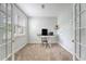 Well-lit office space with neutral carpet, large window, and French doors for privacy at 708 Professor Dr, Ladson, SC 29456