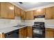 Functional kitchen features wood cabinets, a black range, and a dishwasher at 7920 Parklane Ct # 608, North Charleston, SC 29418