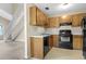 Functional kitchen features wood cabinets, a black range, and a dishwasher at 7920 Parklane Ct # 608, North Charleston, SC 29418