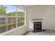 Living room with a fireplace and a scenic view of the pond and building exterior at 7920 Parklane Ct # 608, North Charleston, SC 29418