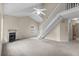 Spacious living room with vaulted ceiling, fireplace, and stairs to the second floor at 7920 Parklane Ct # 608, North Charleston, SC 29418