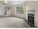 Sunlit living room with a cozy fireplace and sliding glass door to patio at 7920 Parklane Ct # 608, North Charleston, SC 29418