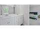 Bathroom featuring double sinks, white cabinets, and a doorway view into an adjacent bedroom at 86 Red Bluff St, Summerville, SC 29483