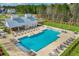 Aerial view of the community pool with a splash pad, a covered pavilion, and plenty of lounge chairs on a sunny day at 86 Red Bluff St, Summerville, SC 29483