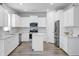 Modern kitchen with white cabinetry, stainless steel appliances, and a center island for food preparation at 86 Red Bluff St, Summerville, SC 29483