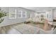 Bright, open-concept living room with hardwood floors, modern furnishings, and abundant natural light at 86 Red Bluff St, Summerville, SC 29483