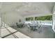 View of community pool pavilion with tables and chairs on a concrete patio and pool in the background at 86 Red Bluff St, Summerville, SC 29483