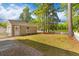 Charming backyard featuring a shed, white picket fence, and lush greenery at 8961 N Red Maple Cir, Summerville, SC 29485