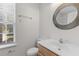 Bright bathroom featuring a vanity, mirror, and window at 8961 N Red Maple Cir, Summerville, SC 29485