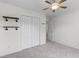 Neutrally painted bedroom with a ceiling fan, wall shelving, and double closet doors at 8961 N Red Maple Cir, Summerville, SC 29485
