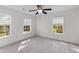 Carpeted bedroom featuring three windows, a ceiling fan, and a neutral color scheme at 8961 N Red Maple Cir, Summerville, SC 29485