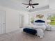 Bedroom featuring tray ceiling, ceiling fan, ample natural light, and ensuite bathroom at 8961 N Red Maple Cir, Summerville, SC 29485