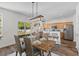 Charming dining area with a rustic wooden table, stylish chairs, and a view of the backyard at 8961 N Red Maple Cir, Summerville, SC 29485