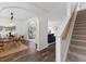 Bright entryway featuring an open floor plan, wood floors, arched doorways, and a staircase at 8961 N Red Maple Cir, Summerville, SC 29485