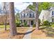 Inviting two-story home with a covered front porch, complemented by manicured landscaping and mature trees at 8961 N Red Maple Cir, Summerville, SC 29485