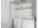 Well-lit laundry room featuring white appliances and a convenient storage shelf at 8961 N Red Maple Cir, Summerville, SC 29485