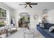 Cozy living room with neutral carpet, comfortable sofa, and view into dining area at 8961 N Red Maple Cir, Summerville, SC 29485