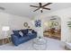 Comfortable living room with a cozy sofa, decorative accents, and seamless flow into the adjacent home office at 8961 N Red Maple Cir, Summerville, SC 29485