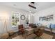 Stylish home office featuring a wooden desk, modern lighting, and large windows for natural light at 8961 N Red Maple Cir, Summerville, SC 29485