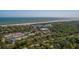Expansive aerial view of the community near the beach, showing tennis courts and lush green landscaping at 9 Marsh Island Ln, Isle of Palms, SC 29451