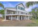 Two-story home with covered patio, spacious deck and lovely outdoor entertaining space at 9 Marsh Island Ln, Isle of Palms, SC 29451