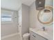 Neutral toned bathroom with a modern vanity, beautiful mirror, and a window letting in lots of light at 9 Marsh Island Ln, Isle of Palms, SC 29451
