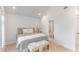 Bedroom with hardwood floors, neutral decor, ensuite bathroom, and plantation shutters at 9 Marsh Island Ln, Isle of Palms, SC 29451