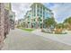 Coastal condos with balconies, manicured lawns, and a communal seating area with fire pit at 9 Marsh Island Ln, Isle of Palms, SC 29451