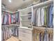 Walk-in closet with custom shelving, drawers, and ample storage space for clothing and accessories at 9 Marsh Island Ln, Isle of Palms, SC 29451