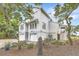 Striking two-story home featuring two-car garage, manicured landscaping, and charming curb appeal at 9 Marsh Island Ln, Isle of Palms, SC 29451