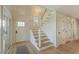Welcoming foyer features stylish staircase, elegant lighting, and beautiful flooring at 9 Marsh Island Ln, Isle of Palms, SC 29451