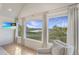 Living room area with a large window providing expansive scenic views and a comfortable chair at 9 Marsh Island Ln, Isle of Palms, SC 29451