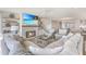Bright living room showcasing a fireplace, large windows, and stylish furnishings at 9 Marsh Island Ln, Isle of Palms, SC 29451