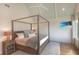Main bedroom features a four-poster bed, flatscreen television, and natural light from the window at 9 Marsh Island Ln, Isle of Palms, SC 29451