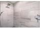 Walk-in shower featuring marble tile surround, overhead shower head, and sleek fixtures at 9 Marsh Island Ln, Isle of Palms, SC 29451