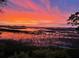 Breathtaking sunset over the marsh, casting vibrant colors across the water and sky at 9 Marsh Island Ln, Isle of Palms, SC 29451