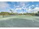 Well-maintained tennis courts with lush landscaping and clear blue skies at 9 Marsh Island Ln, Isle of Palms, SC 29451