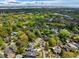 Stunning aerial shot featuring a neighborhood with tree-lined streets and diverse architectural styles at 1 Colleton Dr, Charleston, SC 29407
