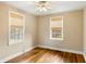 Comfortable bedroom with hardwood floors and natural light from two windows at 1 Colleton Dr, Charleston, SC 29407