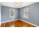 Comfortable bedroom with hardwood floors, ceiling fan, and natural light from two windows at 1 Colleton Dr, Charleston, SC 29407