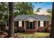Charming brick home with black shutters and a manicured lawn at 1 Colleton Dr, Charleston, SC 29407