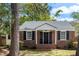 Charming brick home with black shutters and a manicured lawn at 1 Colleton Dr, Charleston, SC 29407