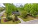 An elevated view of a well-maintained property, mature trees, and lush landscaping on a corner lot at 100 Nighthawk Ln, Summerville, SC 29485